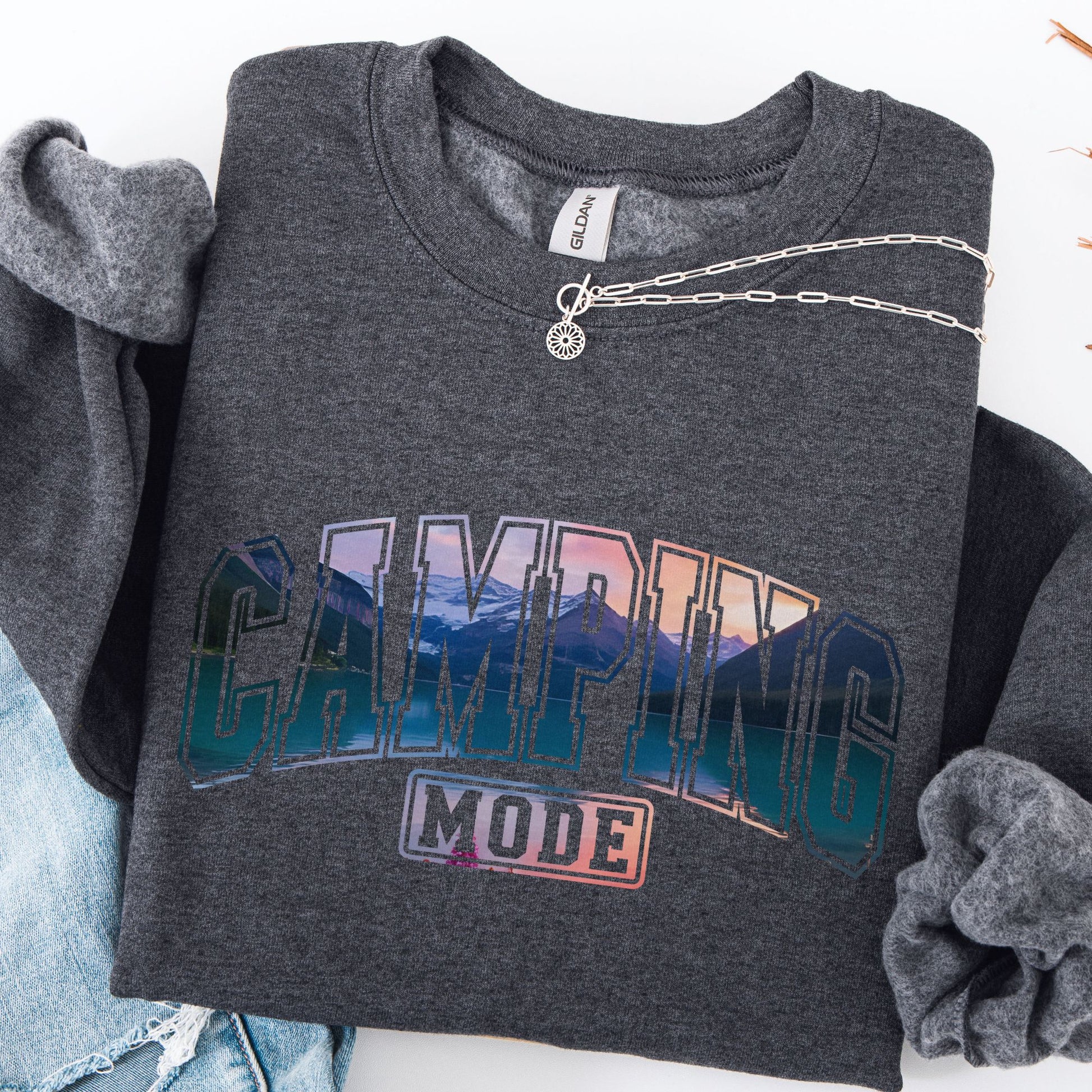 Dark gray sweatshirt with 'Camping Mode' graphic design on a white background