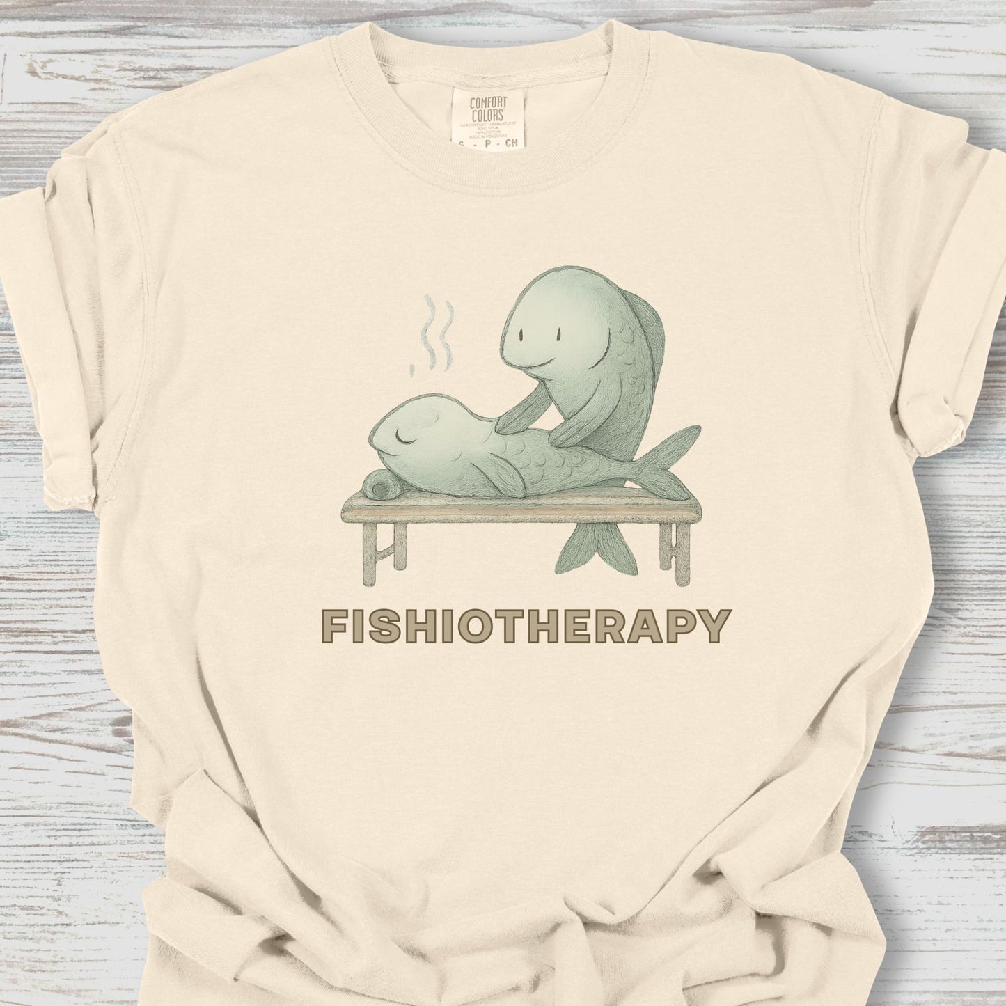 Beige t-shirt with 'Fishiotherapy' graphic featuring two fish on a table.
