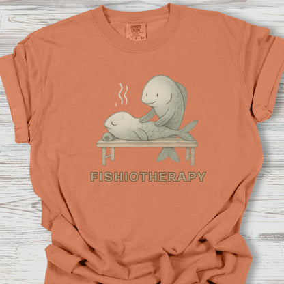 Orange t-shirt with 'Fishiotherapy' graphic on a wooden surface