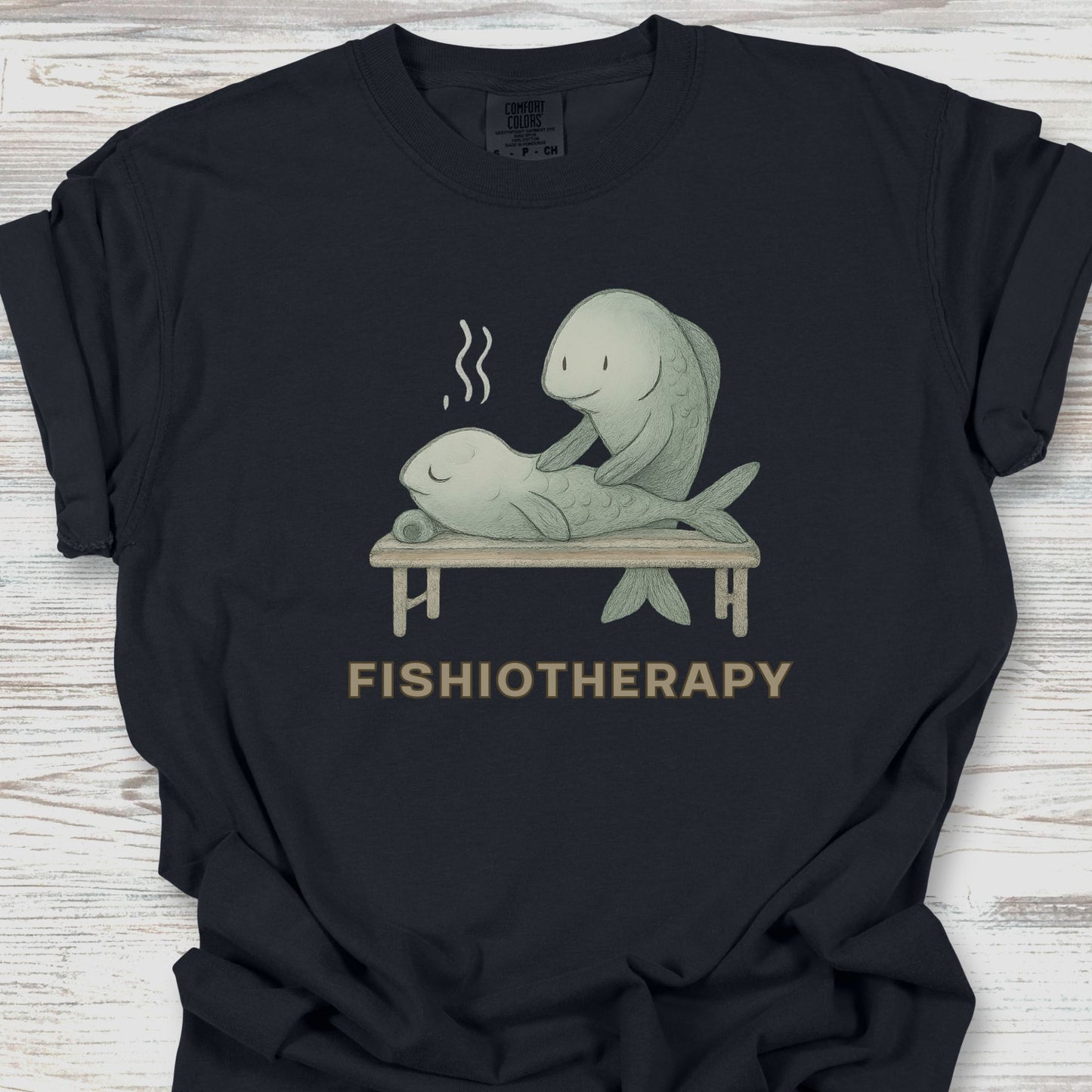 Black t-shirt with 'Fishiotherapy' graphic on a wooden surface