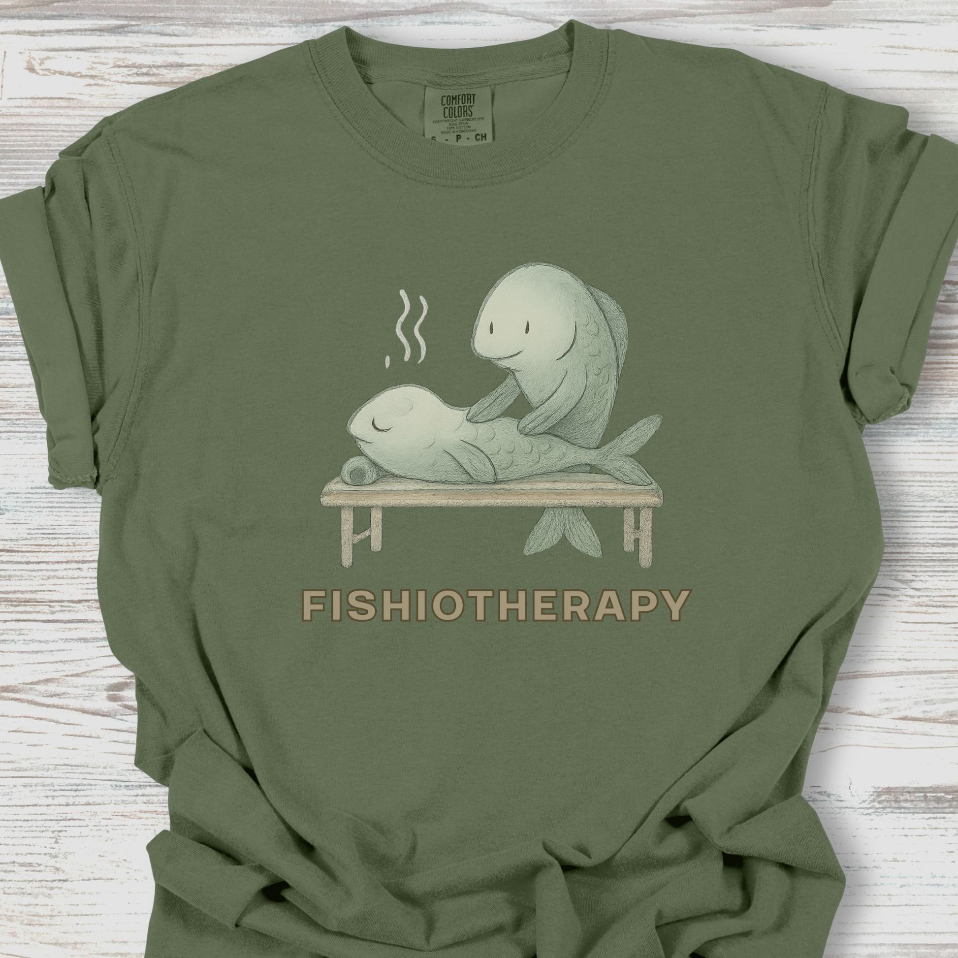 Green t-shirt with 'Fishiotherapy' graphic on a wooden surface