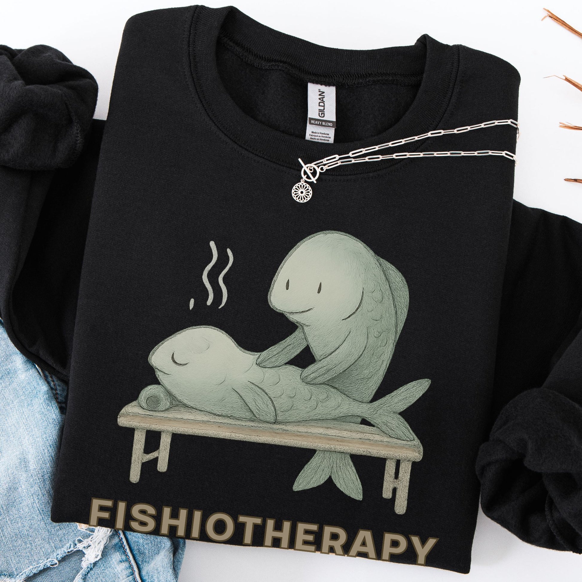 Black sweatshirt with fishiotherapy graphic design on a white background