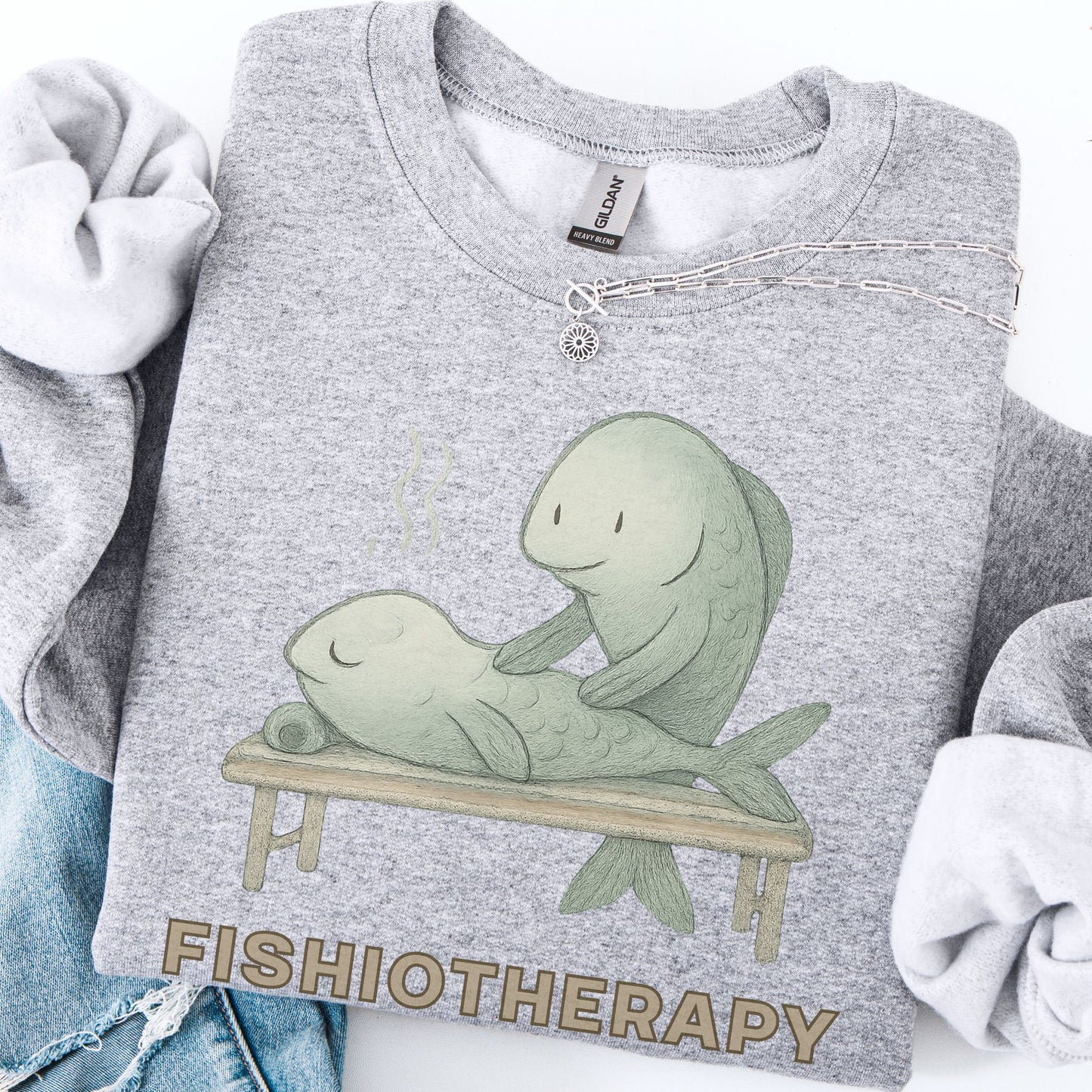 Gray sweatshirt with 'Fishiotherapy' design featuring two fish on a table.