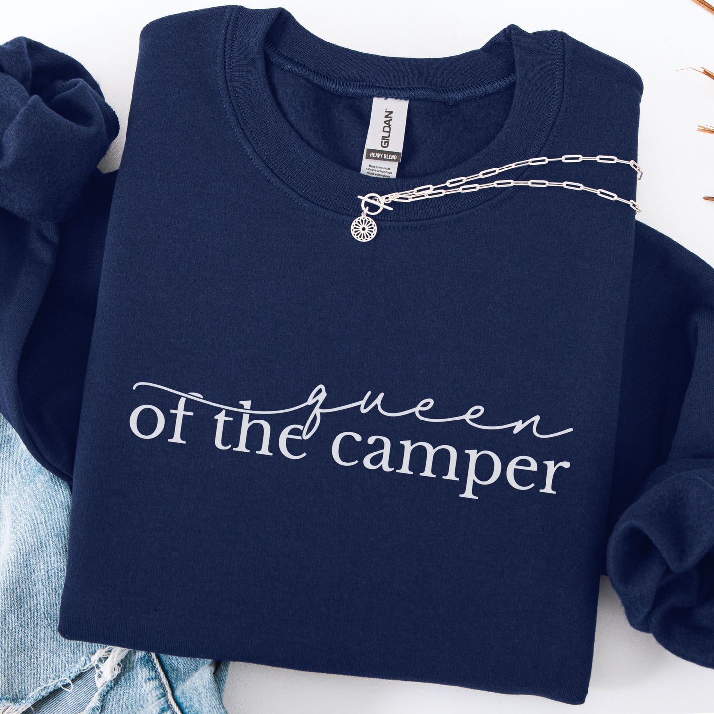 Navy blue sweatshirt with 'queen of the camper' text on a white background