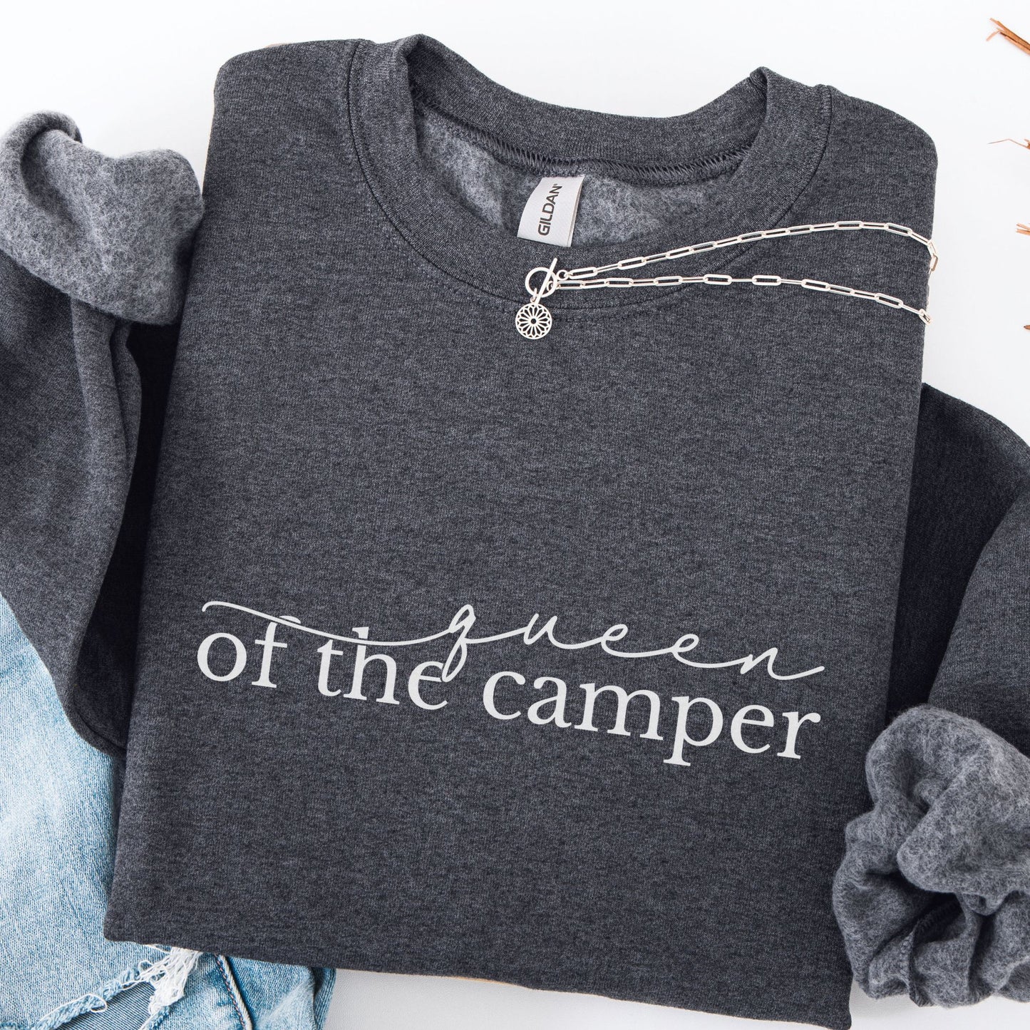 Dark gray sweatshirt with 'Queen of the Camper' text, displayed with denim jeans and a necklace.