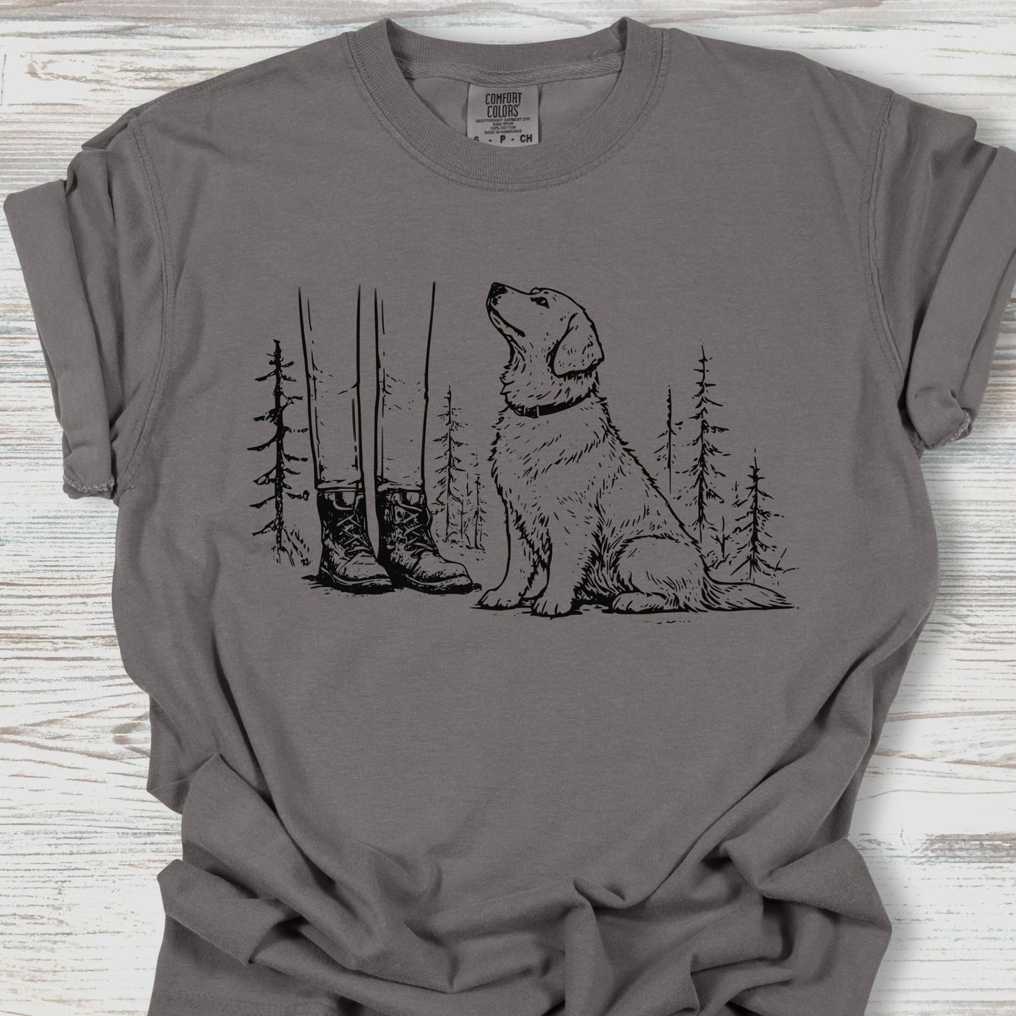 Gray t-shirt with a graphic of a dog and boots on a wooden surface