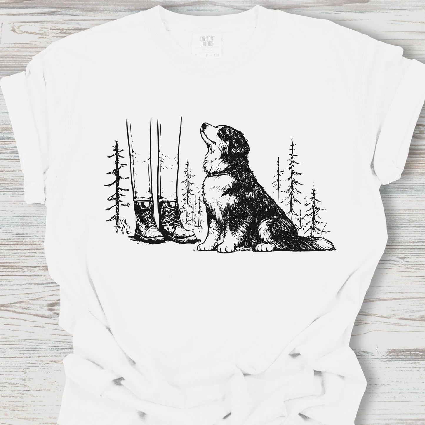 White t-shirt with a graphic of a dog howling at the moon with trees and boots in the background.