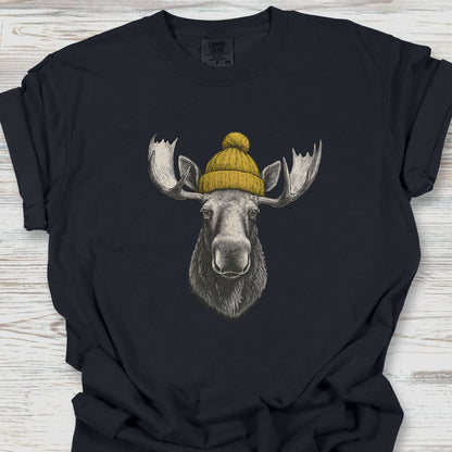 Black t-shirt with a moose wearing a yellow beanie on a wooden surface