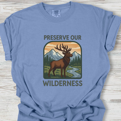Blue t-shirt with a graphic of a deer and mountains, featuring the text 'Preserve Our Wilderness'.