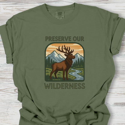 Green t-shirt with a graphic of a deer and mountains, featuring the text 'Preserve Our Wilderness'.