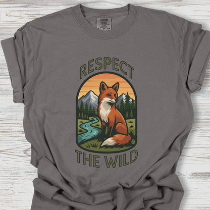 Gray t-shirt with a fox graphic and 'Respect the Wild' text on a wooden surface