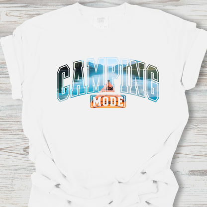 White t-shirt with 'Camping Mode' graphic design on a wooden surface