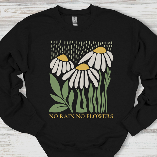 Black sweatshirt with floral design and 'No Rain No Flowers' text on a wooden surface