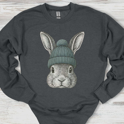 Dark gray sweatshirt with a graphic of a rabbit wearing a green beanie on a wooden surface.