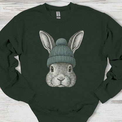 Dark green sweatshirt with a rabbit wearing a beanie on a wooden surface