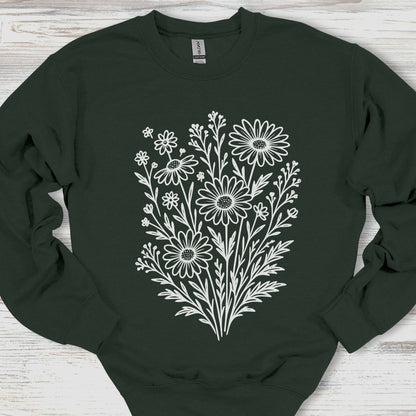 Black sweatshirt with white floral design on a wooden surface