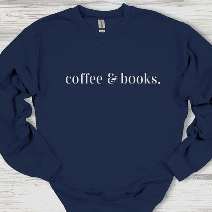Navy blue sweatshirt with 'coffee & books.' text on a wooden surface