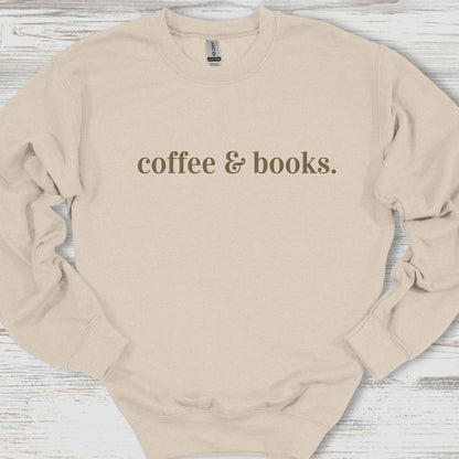 Beige sweatshirt with 'coffee & books.' text on a wooden surface