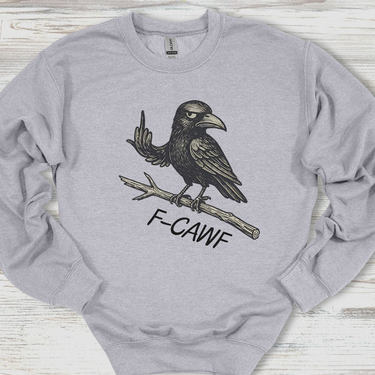 Gray sweatshirt with a black crow design and 'F-CAWF' text on a wooden surface