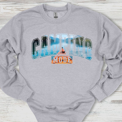 Gray sweatshirt with 'Camping Mode' graphic on a wooden surface