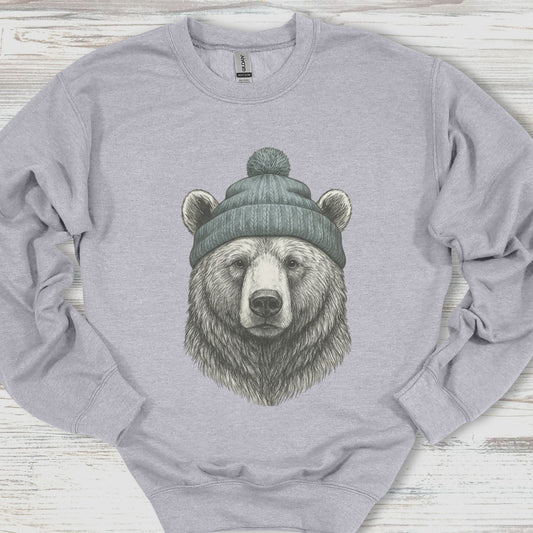 Gray sweatshirt with a bear wearing a beanie on a wooden surface