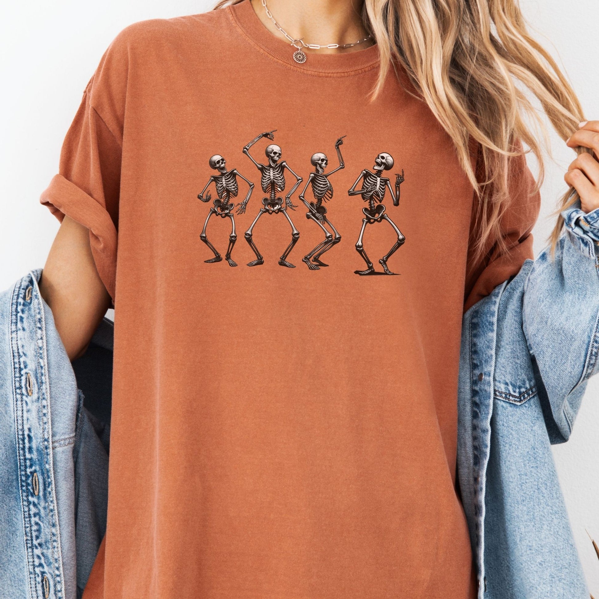 a woman wearing a t - shirt with three skeletons on it