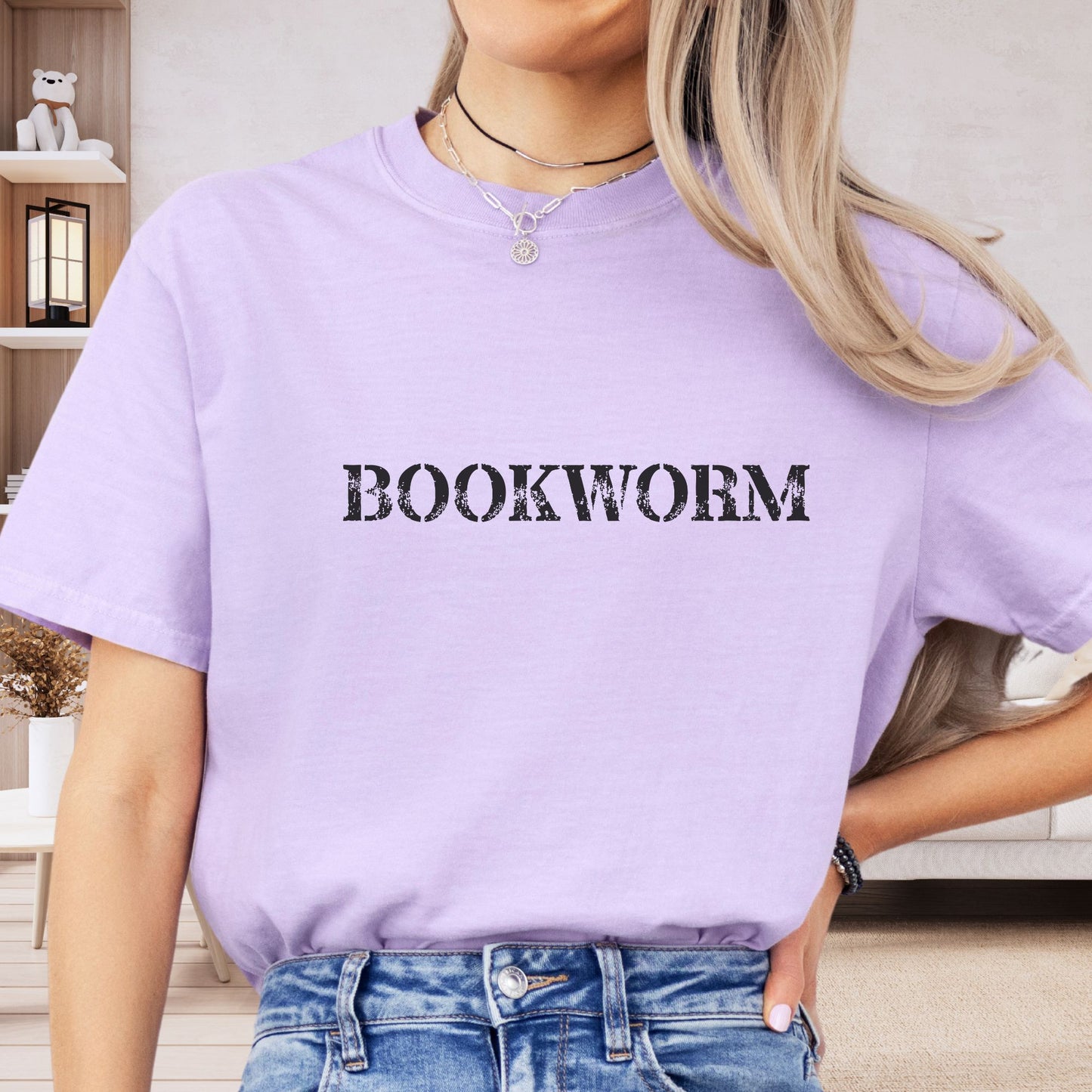 a woman wearing a purple shirt that says bookworm
